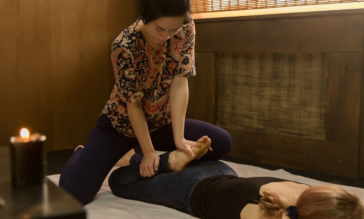 Professional therapist giving traditional Thai massage or Thai yoga massage treatment